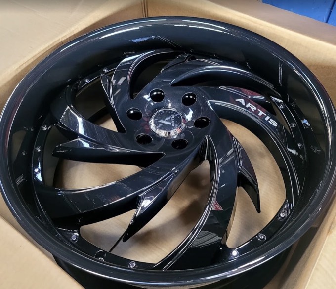 Gloss black Artis custom wheel being unboxed at Smart Tire